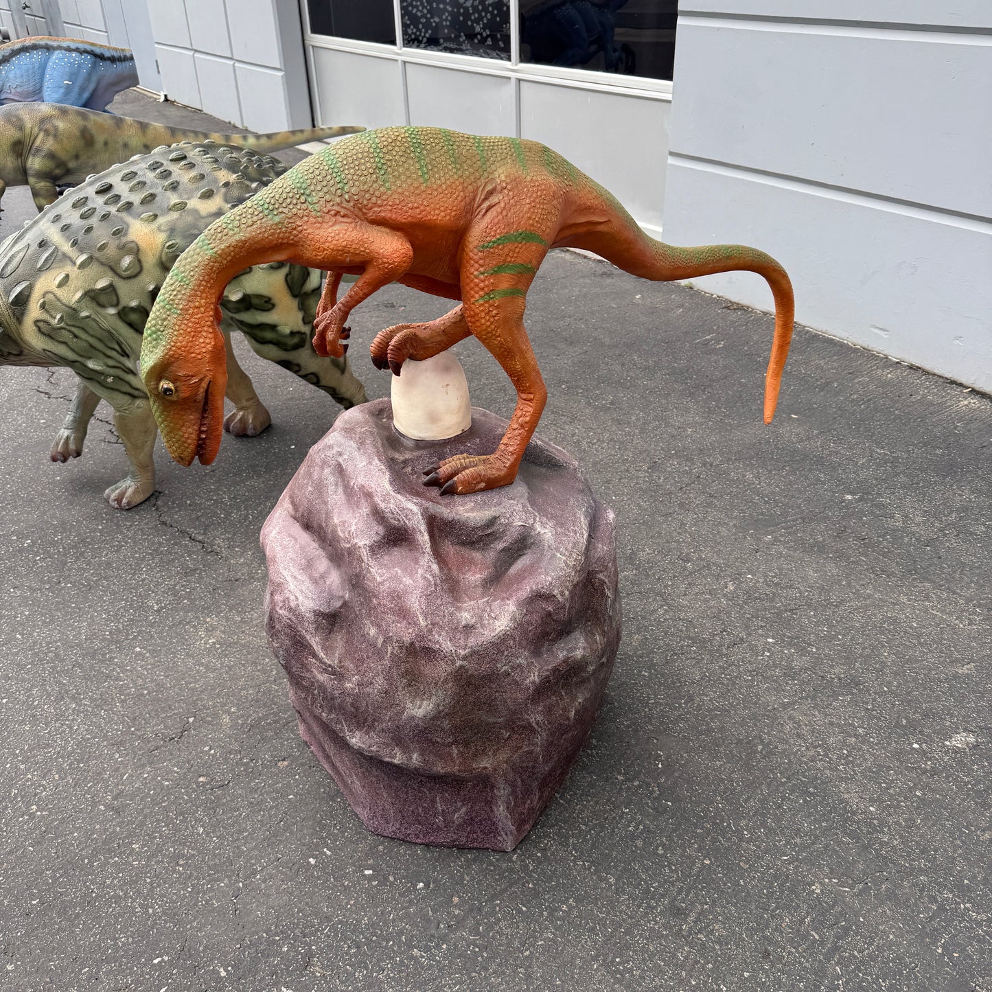Compsognathus Dinosaur On Rock Statue
