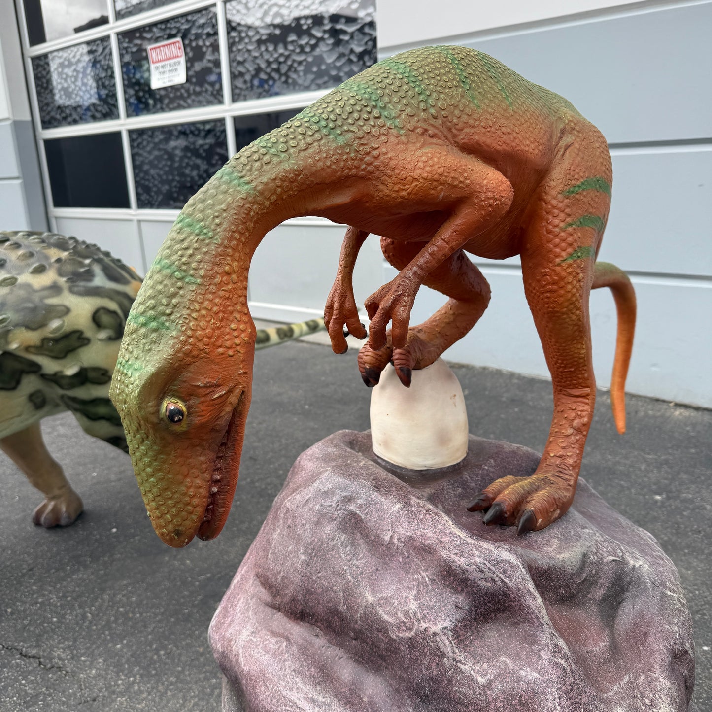 Compsognathus Dinosaur On Rock Statue