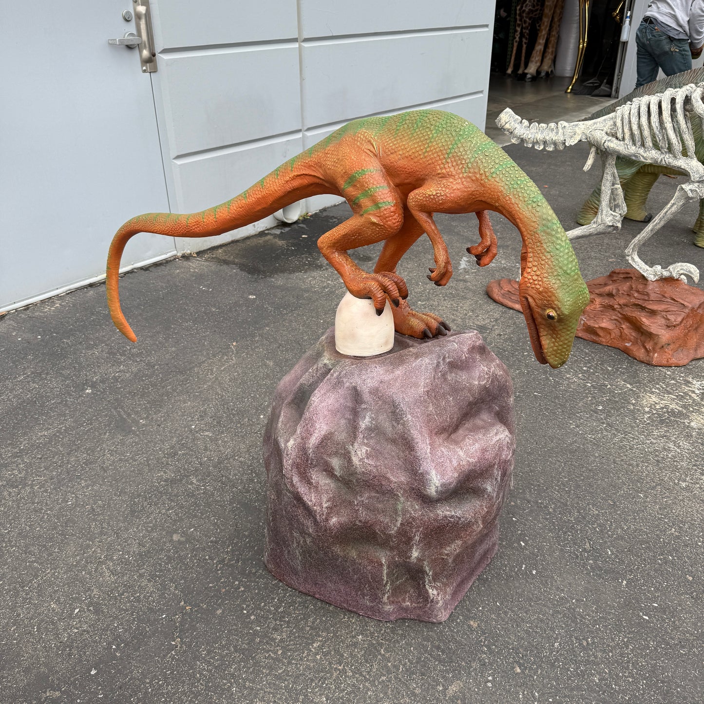 Compsognathus Dinosaur On Rock Statue