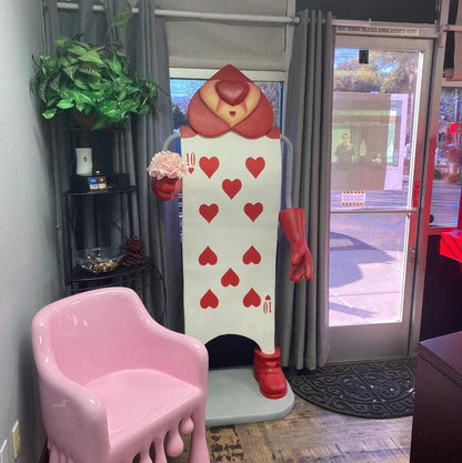 Single Red Playing Card With Staff Statue