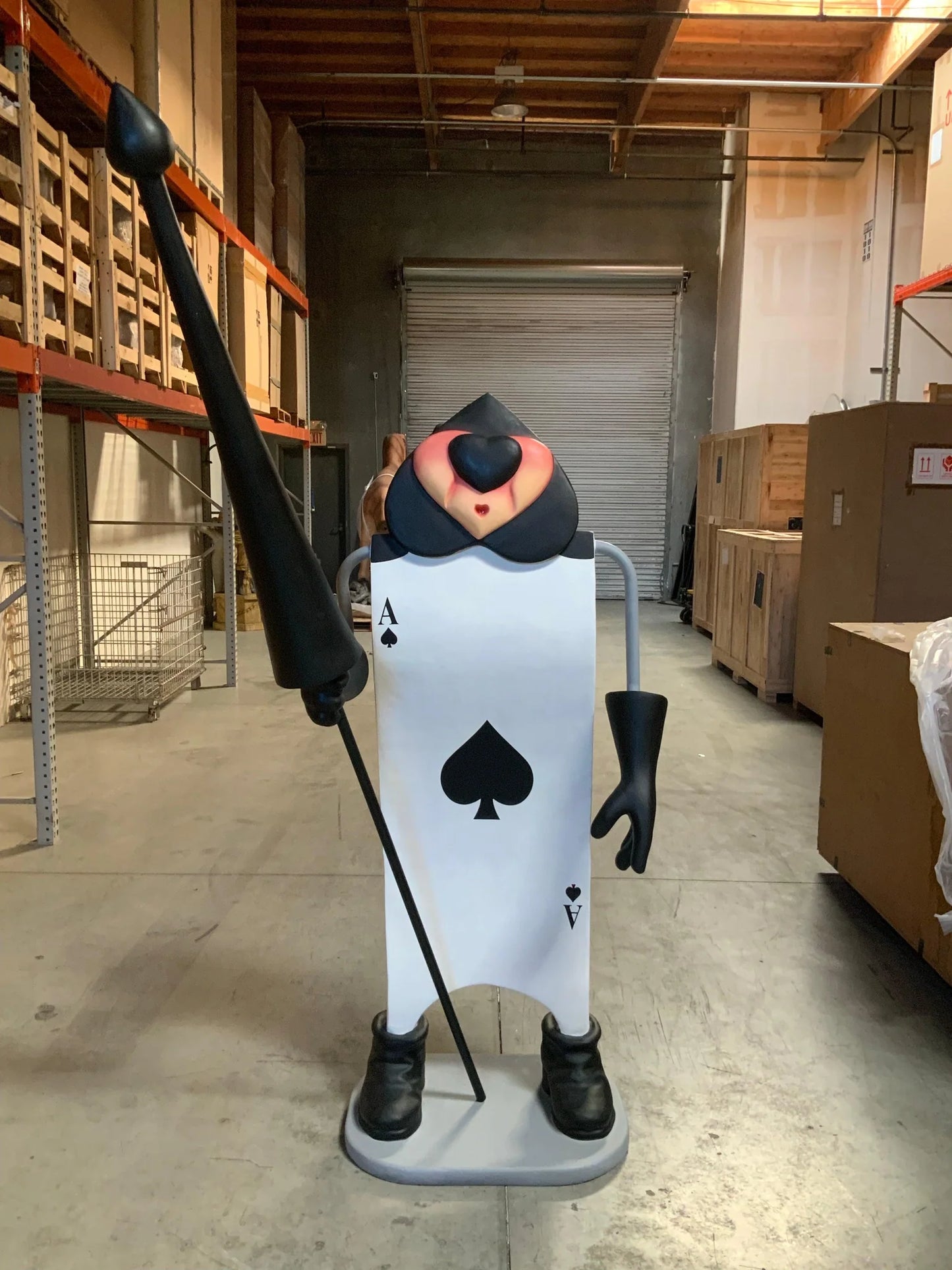 Single Black Playing Card With Staff Statue